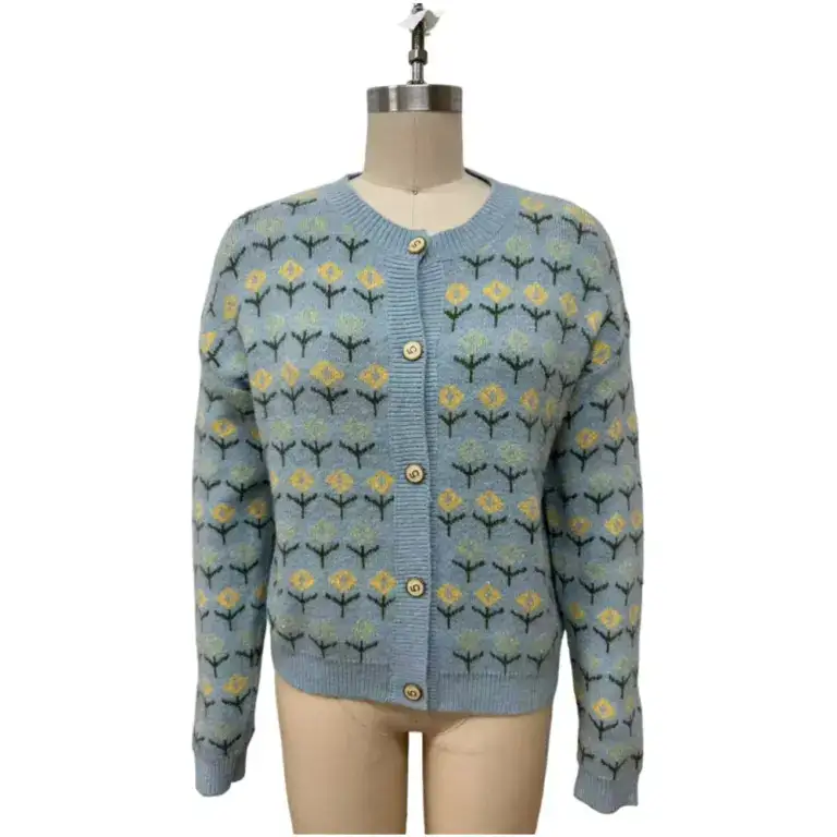 Light blue fine gauge jacquard cardigan with yellow and green floral pattern, button-up front, and ribbed cuffs and collar.