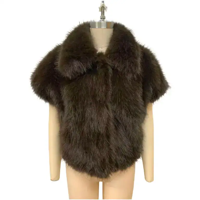 Elegant brown faux fur cape with a wide collar, perfect for winter fashion and adding sophistication to any outfit.