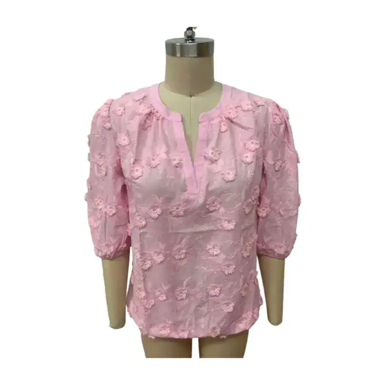 Elegant pink blouse with floral embroidery and puff sleeves, perfect for casual or semi-formal occasions.