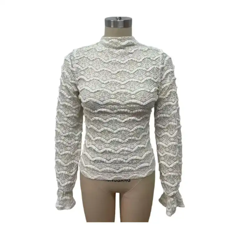 White lace blouse with intricate patterns, high neckline, and long sleeves, perfect for stylish occasions and formal wear.