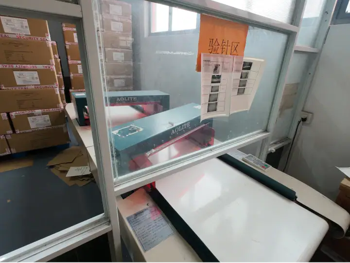Warehouse shipping and packaging station with boxes, labels, and a conveyor belt at NBFish Fashion.