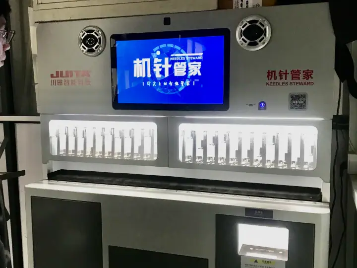 Automated needle sterilization machine with digital display and sterilized needles inside, used in medical settings for hygiene and safety.