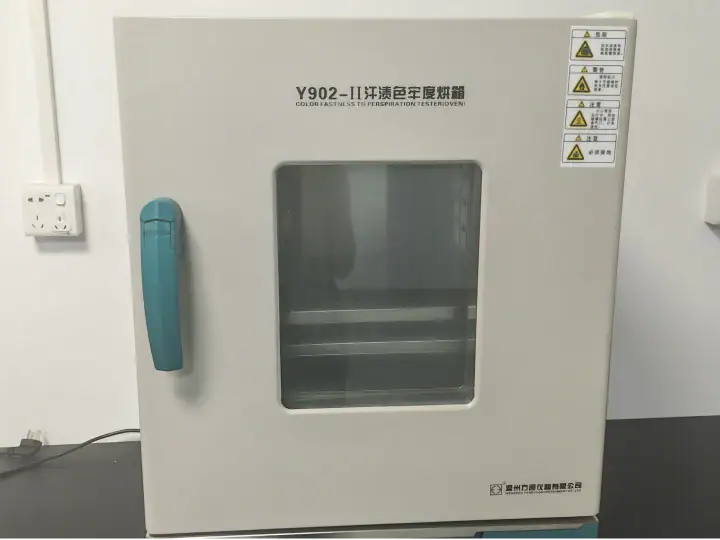 White laboratory incubator with transparent door and blue handle, used for scientific experiments and sample storage.