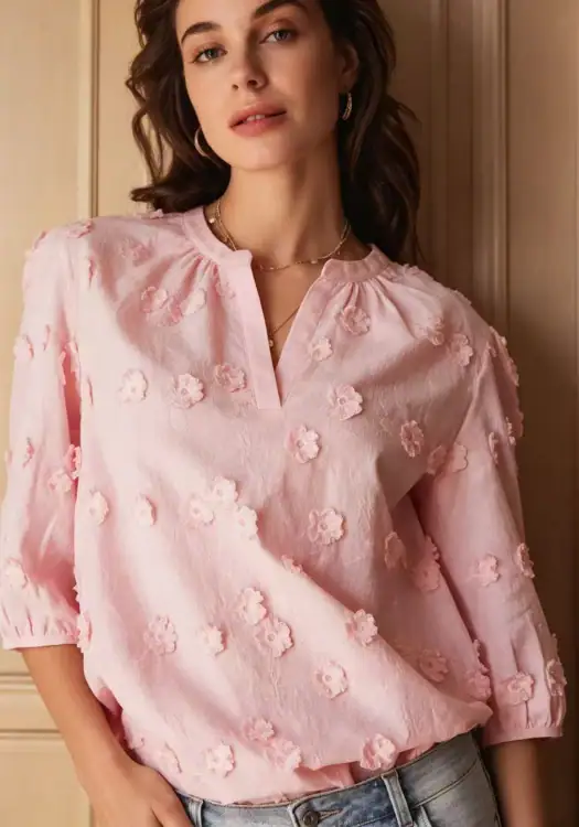 Stylish pink blouse with 3D floral embroidery, perfect for casual or semi-formal occasions, featuring a V-neck and three-quarter sleeves.
