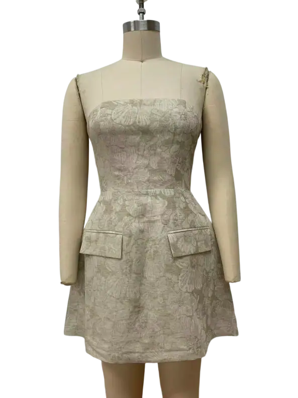 Beautiful beige lace dress with a fitted bodice, sleeveless design, and decorative pockets, perfect for formal events and stylish outings.