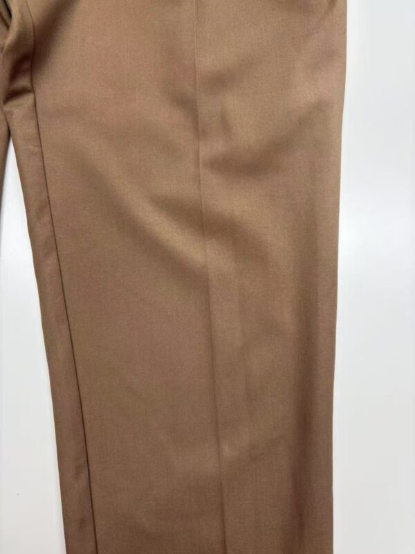 Close-up of stylish brown men's trousers made from high-quality fabric, perfect for formal or business casual wear.
