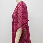Bright pink crochet cover-up with zigzag pattern, perfect for beachwear or summer fashion, displayed on a mannequin against a plain white background.