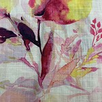 Close-up of a floral fabric pattern featuring pink, yellow, and purple watercolor-style flowers and leaves, ideal for fashion and home decor.