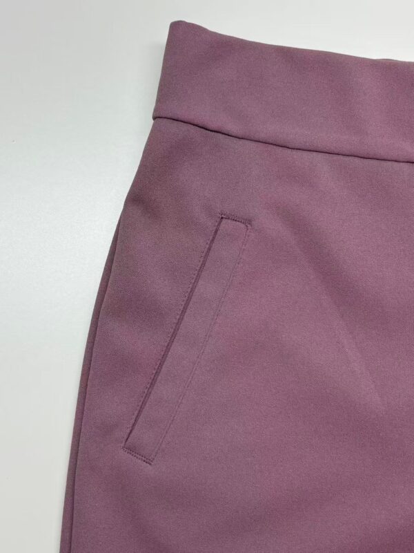 Close-up of mauve women's pants showing the waistband and side pocket, perfect for casual or office wear.