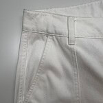 Close-up of white casual pants showing fabric texture, waistband, and front pocket design, ideal for fashion and clothing SEO.