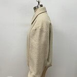 Elegant beige wool coat displayed on a mannequin, perfect for fall and winter fashion, showcasing a classic and timeless style.