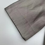 Close-up of smooth gray fabric, ideal for fashion and clothing design, showcasing fine texture and quality material.
