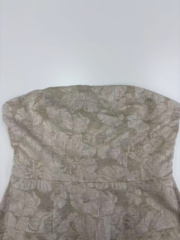 Close-up of a fabric with a subtle floral pattern, suitable for fashion and clothing design projects.