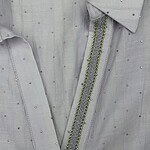 Close-up of a light gray shirt featuring delicate pearl and bead embellishments along the collar and placket, perfect for stylish casual or formal wear.