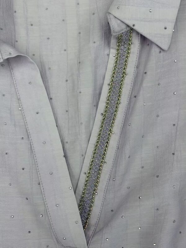 Close-up of a light gray shirt featuring delicate pearl and bead embellishments along the collar and placket, perfect for stylish casual or formal wear.