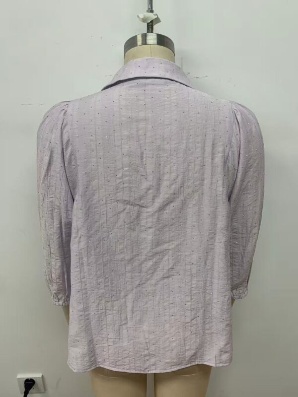 Light pink women's blouse with subtle vertical stripe pattern, long sleeves, and classic collar, perfect for casual or office wear.