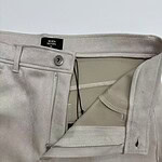 Close-up of light gray men's trousers showing zipper, button, and interior lining for a stylish and comfortable fit.