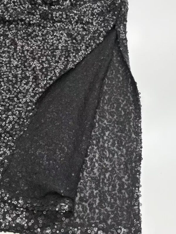 Close-up of a black sequin dress showing intricate sequin pattern and fabric texture for stylish evening wear.