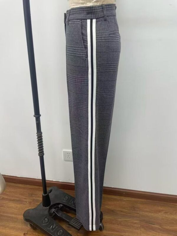 Stylish checked trousers with side white and black stripes, perfect for casual or sporty outfits, displayed on a mannequin in a retail setting.