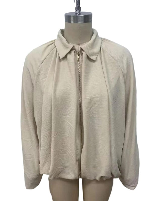 Cream zip-up jacket with a classic collar, long sleeves, and a relaxed fit, perfect for casual or sporty outfits.