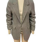 Stylish women's grey blazer with a tailored fit, lapel collar, and structured shoulders, perfect for professional or casual wear.