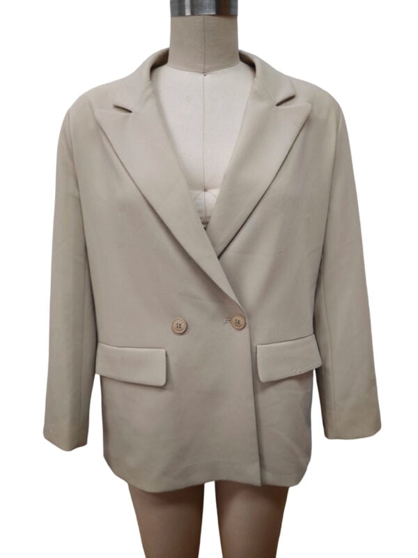 Stylish beige women's blazer with a tailored fit, featuring a notched lapel collar, two-button closure, and flap pockets, perfect for professional or casual wear.