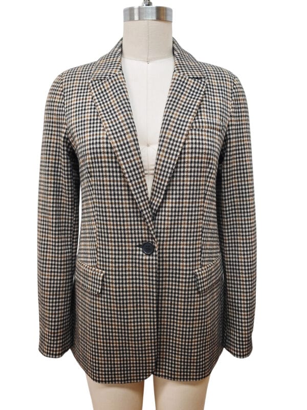 Stylish women's checked blazer with a classic fit, featuring a single button closure and notched lapels, perfect for professional or casual wear.