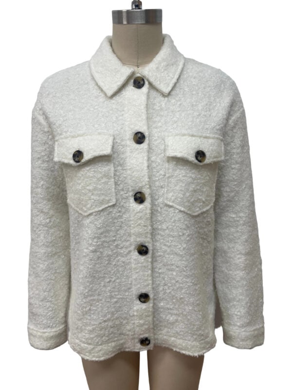 Stylish white woolen jacket with button details and chest pockets, perfect for winter fashion and casual wear.