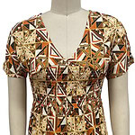 Elegant bohemian dress with a vibrant geometric pattern in warm tones, featuring a V-neckline and short sleeves, perfect for casual or semi-formal occasions.