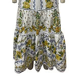 Elegant floral summer dress with spaghetti straps, featuring yellow, green, and blue botanical patterns, perfect for warm weather and outdoor events.