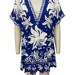 Stylish blue and white floral beach cover-up with a V-neckline, short sleeves, and ruffled hem, perfect for summer beachwear and resort fashion.