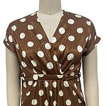 Elegant brown dress with white polka dots, V-neckline, short sleeves, and a waist tie, perfect for casual or semi-formal occasions.