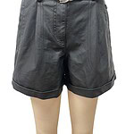 Close-up of black leather shorts with a matching belt, showcasing a trendy and fashionable look for women.