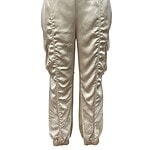 Stylish satin jogger pants in a light beige color with ruched detailing on the sides, perfect for casual or chic outfits.