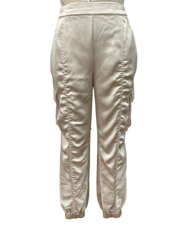 Stylish satin jogger pants in a light beige color with ruched detailing on the sides, perfect for casual or chic outfits.