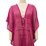 Vibrant pink crochet cover-up with zigzag pattern, featuring a front tie and loose fit, perfect for beach or poolside fashion.