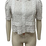 White eyelet lace blouse with short puff sleeves, button-up front, and scalloped collar, perfect for summer or casual wear.