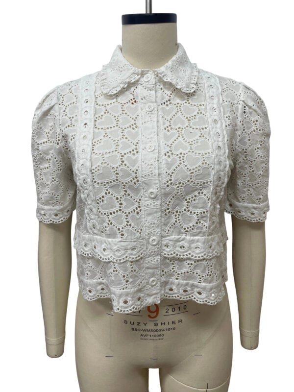 White eyelet lace blouse with short puff sleeves, button-up front, and scalloped collar, perfect for summer or casual wear.