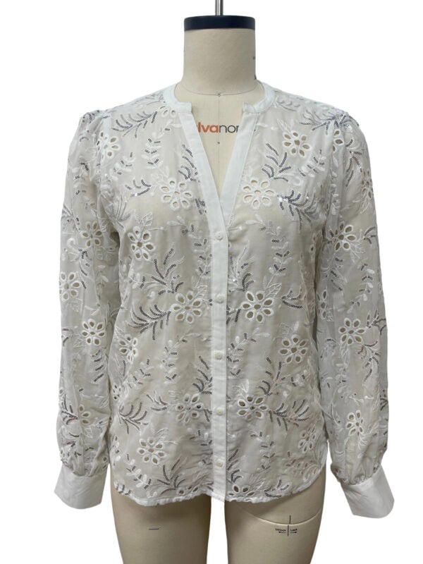 White embroidered blouse with floral cutouts, long sleeves, and a round neckline, perfect for casual or semi-formal occasions.