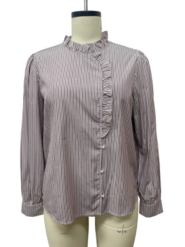 Elegant women's blouse with vertical black and white stripes, ruffled front detail, high neckline, and long sleeves, perfect for office or casual wear.