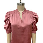 Stylish pink satin blouse with puff sleeves and a V-neckline, perfect for formal or casual occasions.