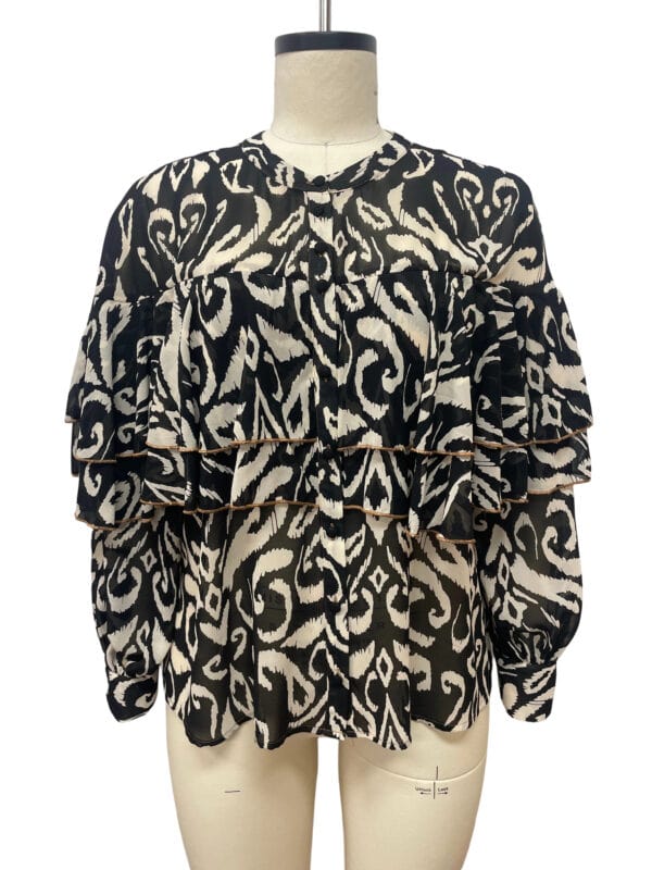 Stylish women's blouse with black and beige animal print, featuring ruffled layers and long sleeves, perfect for casual or semi-formal occasions.