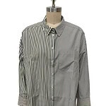 Women's long-sleeve striped button-down shirt with vertical black and white lines, classic collar, and front button closure, displayed on a mannequin.