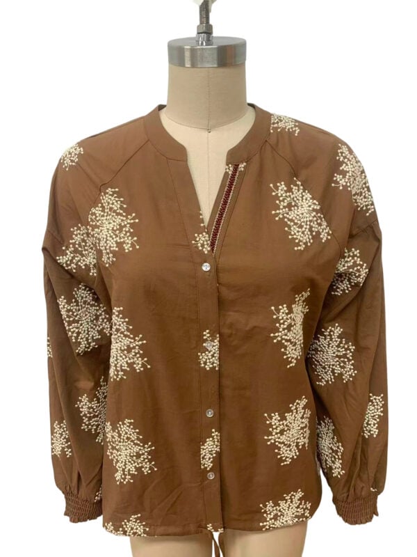 Elegant brown jacket with white floral print, front zipper, and elastic cuffs, perfect for casual or semi-formal wear.
