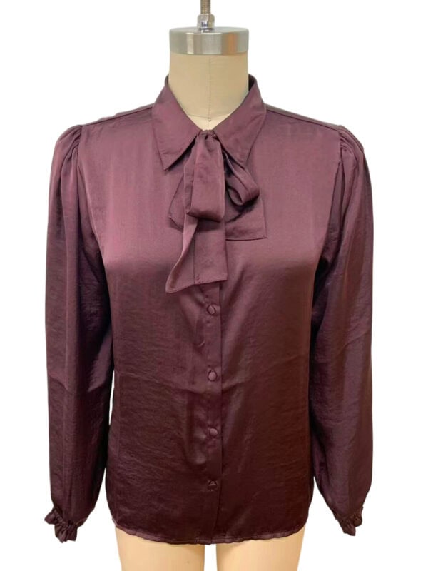 Elegant burgundy satin blouse with a bow tie collar, long sleeves with elastic cuffs, perfect for formal or office wear.