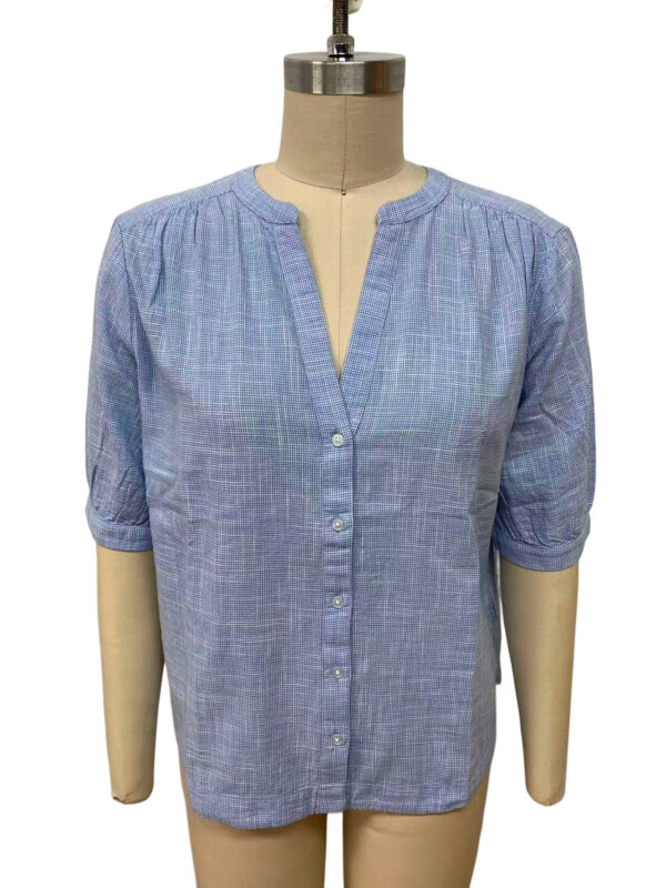 Light blue linen blouse with a V-neck, button-down front, and rolled-up sleeves, perfect for casual or office wear.
