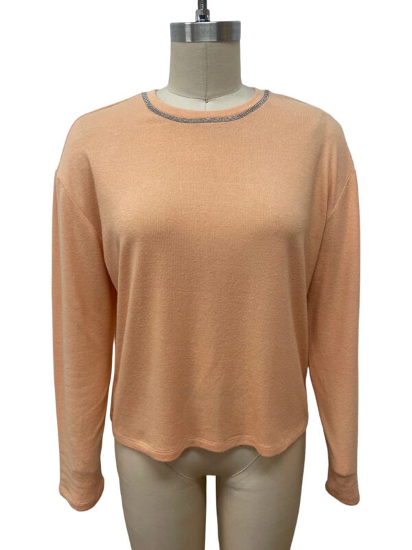Stylish peach-colored women's knit sweater with gray trim around the neckline, perfect for casual or office wear.