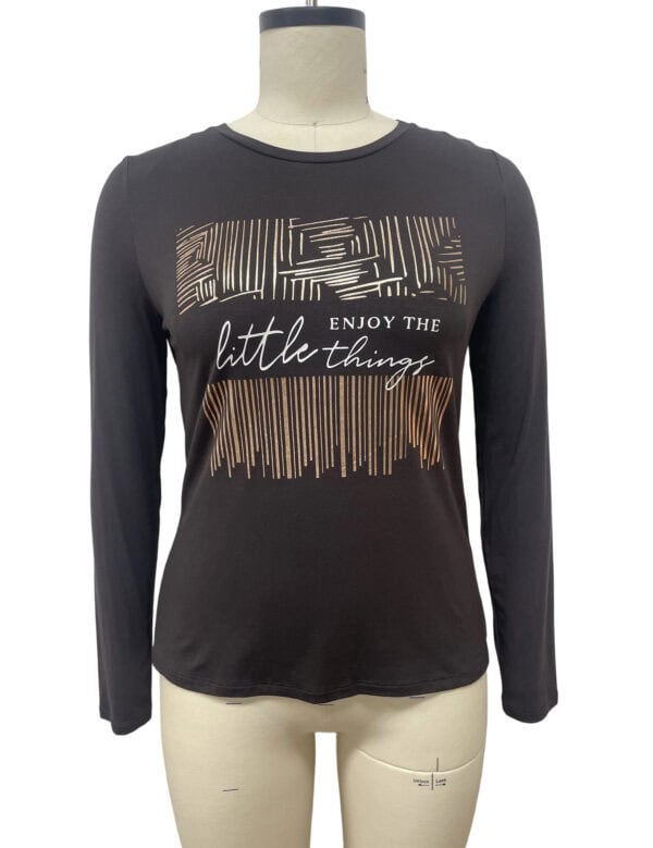Black long sleeve women's T-shirt with geometric and striped design and the phrase 'Enjoy the little things' in white script.