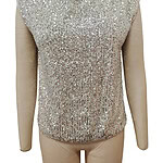 Shimmering sleeveless top covered in silver sequins, perfect for evening wear or special occasions, displayed on a mannequin.