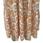 Elegant bohemian floral maxi skirt with layered ruffles, featuring a white base with yellow and brown floral patterns, perfect for summer and casual wear.